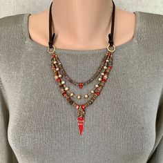 Extra Spicy Elevate your bohemian style with this stunning Sundance Style mixed gems and leather necklace.  Featuring multi strands: the bottom strand is composed of vibrant coral, earthy Quartz, red malachite and  rich jasper, the middle row is cultured pearls and the top row is of mystical chocolate moonstone and coral.  This adjustable piece is a true statement maker. This colorful necklace is accented with gold plated beads and real leather lace for a touch of luxury.    To top it all off, a Bohemian Leather Necklace For Festivals, Bohemian Handmade Necklaces For Accessorizing, Bohemian Brown Leather Necklace, Handmade Bohemian Leather Necklace, Bohemian Beaded Leather Jewelry, Bohemian Leather Jewelry, Sundance Style, Colorful Necklace, Colourful Necklace