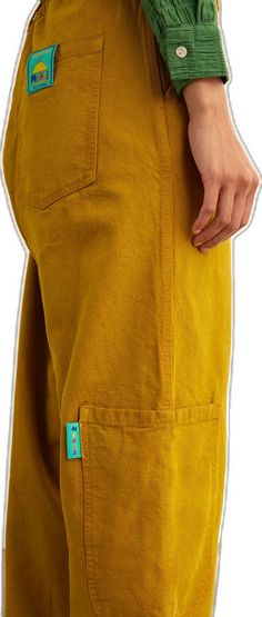 Organic Cotton Long Pants With Pockets, Casual Organic Cotton Pants With Pockets, Yellow Cotton Cargo Pants, Yellow Cotton Pants With Cargo Pockets, Casual Organic Cotton Bottoms With Pockets, Yellow Cotton Cargo Pants With Pockets, Yellow Cotton Bottoms With Side Pockets, Mustard Trousers With Pockets, Mustard Cotton Pants For Fall