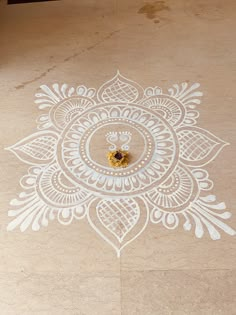 an intricately decorated floor with a flower design on the ground and a small yellow object in the middle