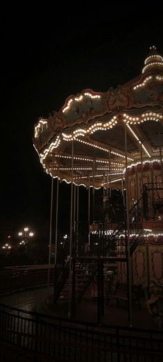 a merry go round at night with lights on it