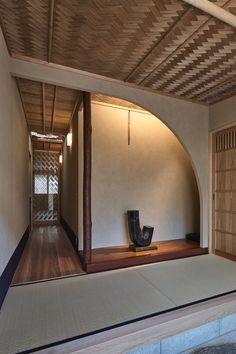 an empty room with a wooden door and chair on the floor in front of it