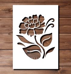 a paper cut flower on a wooden background