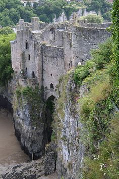 an old castle built into the side of a cliff