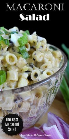 macaroni salad in a glass bowl with green onions