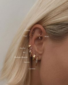 a woman with blonde hair wearing three gold ear cuffs and two small diamond studs