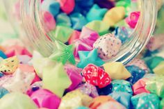 a glass jar filled with lots of colorful candies