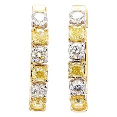 RareGemWorld's classic diamond earrings. Mounted in a beautiful 18K Yellow and White Gold setting with natural cushion cut yellow diamonds. The yellow diamonds are surrounded by round natural white diamond melee. These earrings are guaranteed to impress and enhance your personal collection! Total Weight: 1.86cts Length x Width: 21.6 x 17.8 mm Yellow Diamond Measurements: 3.3 x 3.1 mm White Diamond Measurements: 3.1 - 3.2 mm Natural Cushion Yellow Diamonds Natural Round White Diamonds 18k Yellow/White Gold All diamonds are guaranteed natural International Shipments: Please note that customers are responsible for all import duties and taxes applicable to the country of shipment Returns: Returns accepted in original format within 14 days of receipt Do not forget to view our entire inventory! Classic Diamond Earrings, Round Cut Diamond Earrings, Earring Video, Modern Hoop Earrings, Yellow Cushion, Gold Diamond Hoop Earrings, Yellow Diamonds, Gold Cushions, Natural Cushions