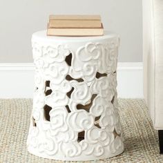 a white stool sitting on top of a rug