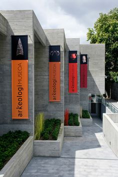 an outdoor area with several planters and banners on the side of the building,