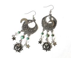 "Fun, flirty earrings with celestial charm that feature sun, half moon, and star charms swinging from filigree pendants with turquoise magnesite and glass bead accents! It's a super-cute pair of earrings to slip on to add that funky finishing touch to your outfits! And the're lightweight, too, so they're really comfortable to wear...no pulling as they swing! Choose your earwires...sterling silver or silver-plated! Sterling Silver/Silver-plated Earwires, Silver-plated Filigree Pendants 1\" round, Adjustable Celestial Charms Jewelry, Festival Drop Earrings With Dangling Charms, Festival Jewelry With Dangling Charms, Festival Jewelry Drop Earrings With Dangling Charms, Festival Jewelry With Dangling Drop Earrings, Celestial Sun And Moon Dangle Jewelry, Celestial Metal Jewelry With Charms, Celestial Style Metal Jewelry With Charms, Celestial Metal Charms Jewelry