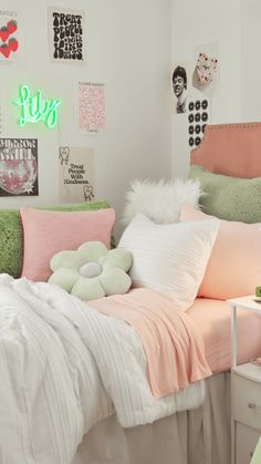 a bedroom with pink, green and white decor