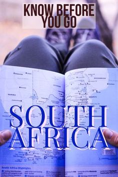 a person holding an open book with the words south africa on it in front of them