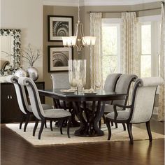 a dining room table with chairs and a chandelier