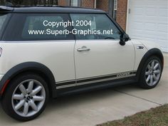 a white and black car parked in front of a house