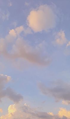 two airplanes are flying in the sky with clouds