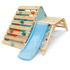 a wooden play set with a blue slide and orange balls on the top of it