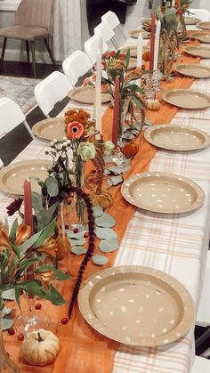 the table is set with plates and place settings for an autumn themed dinner or brunch