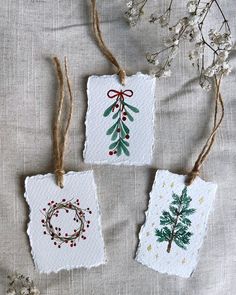 three handmade christmas cards hanging from twine