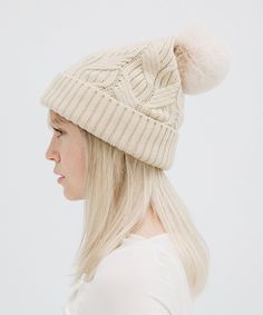 A winter classic. The Ida is a chic cable knit beanie with a classic silicon Gigi Pip label + fluffy faux fur pom in 3 staple colors. This lightweight fold over style is exactly what you need to keep you warm throughout the chilly winter szn, whether your home town is a snowy tundra or even just gets below 50's! Create the ultimate monochromatic winter look by pairing with other popular styles from the Winter Resort Collection HERE! Winter Cable Knit Beanie One Size, Cozy Cable Knit Winter Hat, Winter Cable Knit Hats For Cold Weather, Cold Weather Cable Knit Hat, Cozy Cable Knit Beanie For Cold Weather, Cozy Cable Knit Beanie For Winter, Cozy Cable Knit Winter Beanie, Winter Cable Knit Beanie, Cold Weather Hats With Pom Poms