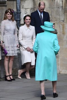 the royal family are walking together in front of an old stone building with two women and one man