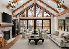 a living room filled with furniture and a fire place in front of a large window