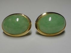 "This is for a pair of ladies 1960-1980's 2/3\" length x 1/3\" width 14k yellow gold lightly dyed green color Natural Jadeite Jadeite gemstone earrings. The earrings consist of two bezel sets, very good oval cabochon cut, slightly dyed color green, translucent in clarity with good polish Jadeite Jadeite gemstones. The gemstones measure approximate 14.0 mm x 10.0 mm x 4.0 mm, 2/3\" x 1/3\" width. This classic motif earrings are pierced post back stamped 585 with working butterfly style clutches. Finish and condition of this pair of earrings is very good, weighing 4.0 grams. All items evaluated by a Graduate Gemologist (GIA). Diamonds, gemstone weights and measurements are approximated." Green Oval Earrings For Formal Occasions, Formal Jade Earrings, Jade Cabochon Jewelry For Wedding, Jade Cabochon Earrings As A Gift, Classic Green Clip-on Earrings For Formal Occasions, Formal Yellow Gold Jade Earrings, Elegant Green Oval Clip-on Earrings, Classic Green Clip-on Earrings, Oval Green Clip-on Earrings