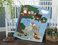 a baby crib with an animal themed blanket