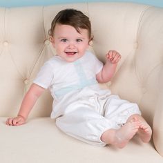 "Finn White Linen Jumpsuit Original Price $115 - SALE $38- FINAL SALE A soft and elegant linen jumpsuit for your little guy's special day! Our Finn linen jumpsuit is made with a soft linen and cotton blend in white. Featuring a cotton ribbon in the most beautiful shade of sky blue on the bodice along with shell buttons. Snaps along the inside legs as well as three buttons on the back bodice make this jumpsuit convenient for quick and simple changes. Made to fall mid-calf to ankle length dependin White Short Sleeve Bubble Romper For Baptism, Fitted White Bubble Romper For Play, White Fitted Bubble Romper For Playwear, Fitted White Onesie For Baptism, White Fitted Onesie For Baptism, Fitted Cotton Bodysuit For Baptism, White Summer Onesie For Baptism, White Onesie For Baptism In Summer, Fitted Cream Onesie For Summer