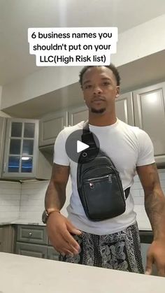 a man holding a black backpack in his kitchen