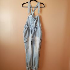 Denim Romper; Cargo Pockets; Jogger Pants Utility High Rise Medium Wash Overalls, Utility Style High Rise Medium Wash Overalls, Light Wash High Waist Cotton Overalls, High Waist Light Wash Cotton Overalls, Casual Light Wash Overalls, High Rise Washed Blue Overalls For Spring, High-rise Washed Blue Overalls For Spring, High Rise Cotton Overalls In Medium Wash, High Rise Light Wash Cotton Overalls