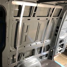 the inside of a van with its door open and windows missing from it's interior