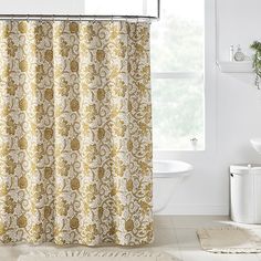 a bathroom with a shower curtain and rug