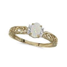 a white opal and diamond ring on a white background