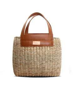 Make even the most relaxed outfits that little bit more chic with this basket bag by Khokho Collection. It’s handwoven by the brand’s all-female team of artisans from locally-sourced natural fibers and finished with tan leather handles and trims. Wear yours with a lightweight linen suit as soon as the weather heats up. - Top handles, open top - Natural fibers, cow leather - Any variations in tone or texture are inherent to the handcrafted nature of each bag - Artisanally crafted by a local femal Spring Beach Bag In Natural Woven Leather, Spring Natural Woven Leather Beach Bag, Spring Season Natural Woven Leather Beach Bag, Chic Natural Bucket Bag With Top Handle, Chic Natural Color Top Handle Bucket Bag, Chic Jute Straw Bag With Woven Leather, Chic Straw Bag With Woven Leather Details, Chic Handwoven Natural Fiber Bucket Bag, Eco-friendly Woven Leather Bucket Bag