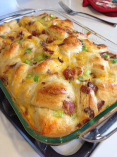 a casserole dish with meat, cheese and vegetables in it on a green tray