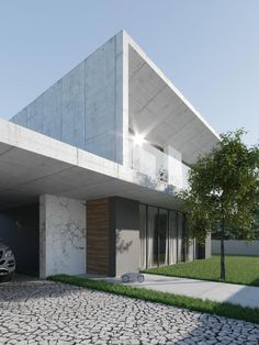 a car is parked in front of a modern building with grass and rocks on the ground