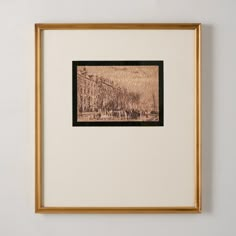 a painting hanging on the wall in front of a white wall with a gold frame