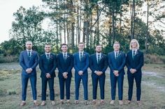 a group of men in suits standing next to each other