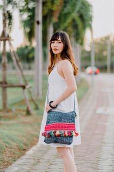 This beautiful crossbody bag is made with an amazing piece of fabric woven by the HMONG hill tribes of Lanna Country (Northern Thailand). It has multi pom pom tassels and It's a great bag for carrying anything. It features a zippered opening area and inside zippered pocket. We buy materials from Hmong market and we design and sew by hand. Some of the bags we modify to improve the product. The Hmong tribes live in the North of Thailand and have origins from the Tibetan area of China. ------------ Festival Bags, Sew By Hand, Boho Wallet, Ethnic Bag, Hippie Bags, Northern Thailand, Festival Bag, Boho Bag, Unique Gifts For Her