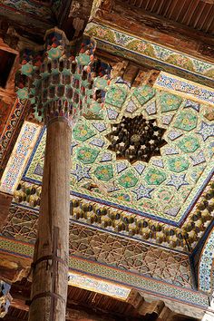 an intricately decorated ceiling in the middle of a room with wooden beams and tilework