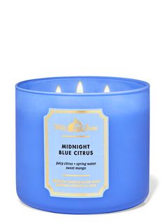 a blue candle that is sitting in front of a white background with the words midnight blue citrus