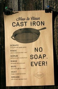 a sign that says how to clean cast iron no soap ever hanging on a wooden fence