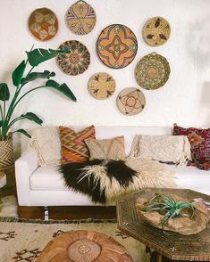 a living room filled with furniture and plates on the wall