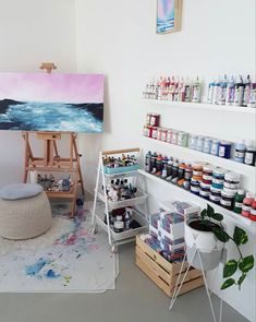 an artist's studio with lots of paint and supplies