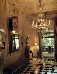 an ornate room with chandelier and checkered floor