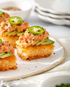 small appetizers are arranged on a white plate