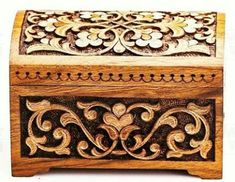 an ornate wooden box with carvings on it