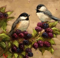 two birds are perched on top of berries