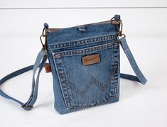 a small denim purse with an adjustable strap