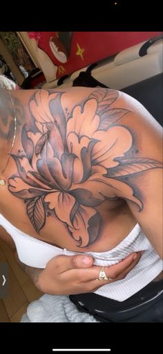 a woman with a flower tattoo on her chest